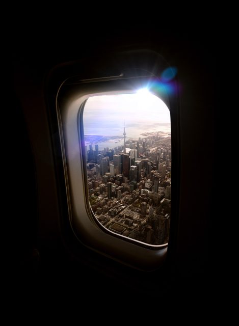 Aerial view of Downtown Toronto through an airplane window.